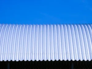 front-view-curved-steel-roof-against-blue-clear-sky-background_11zon